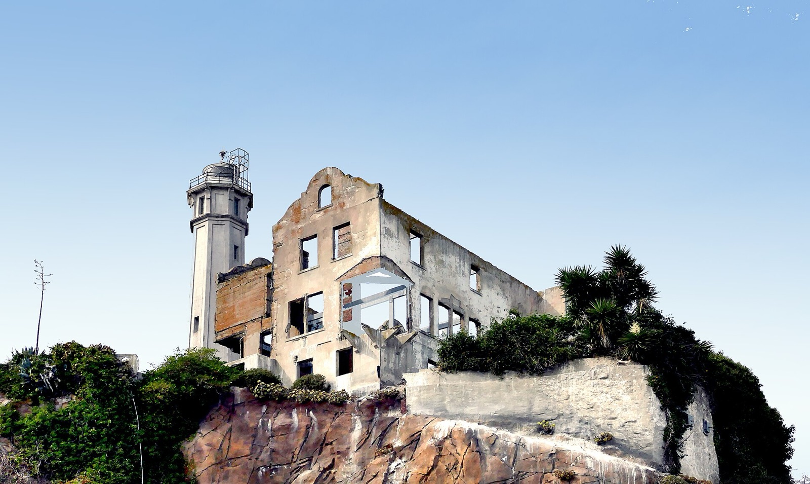 Ruins of the warden's house with the Alcatraz lighthouse behind them